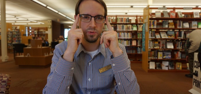 Alex Andrasik adjusting his glasses