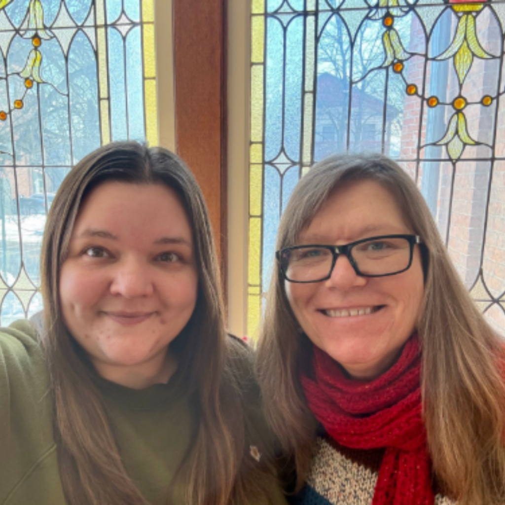 photo of jess westlake and karin thomas together in front of stained glass windows in the montour falls library